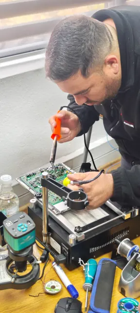 Trabajo de reparación sobre una placa electrónica con herramientas de banco en Chile